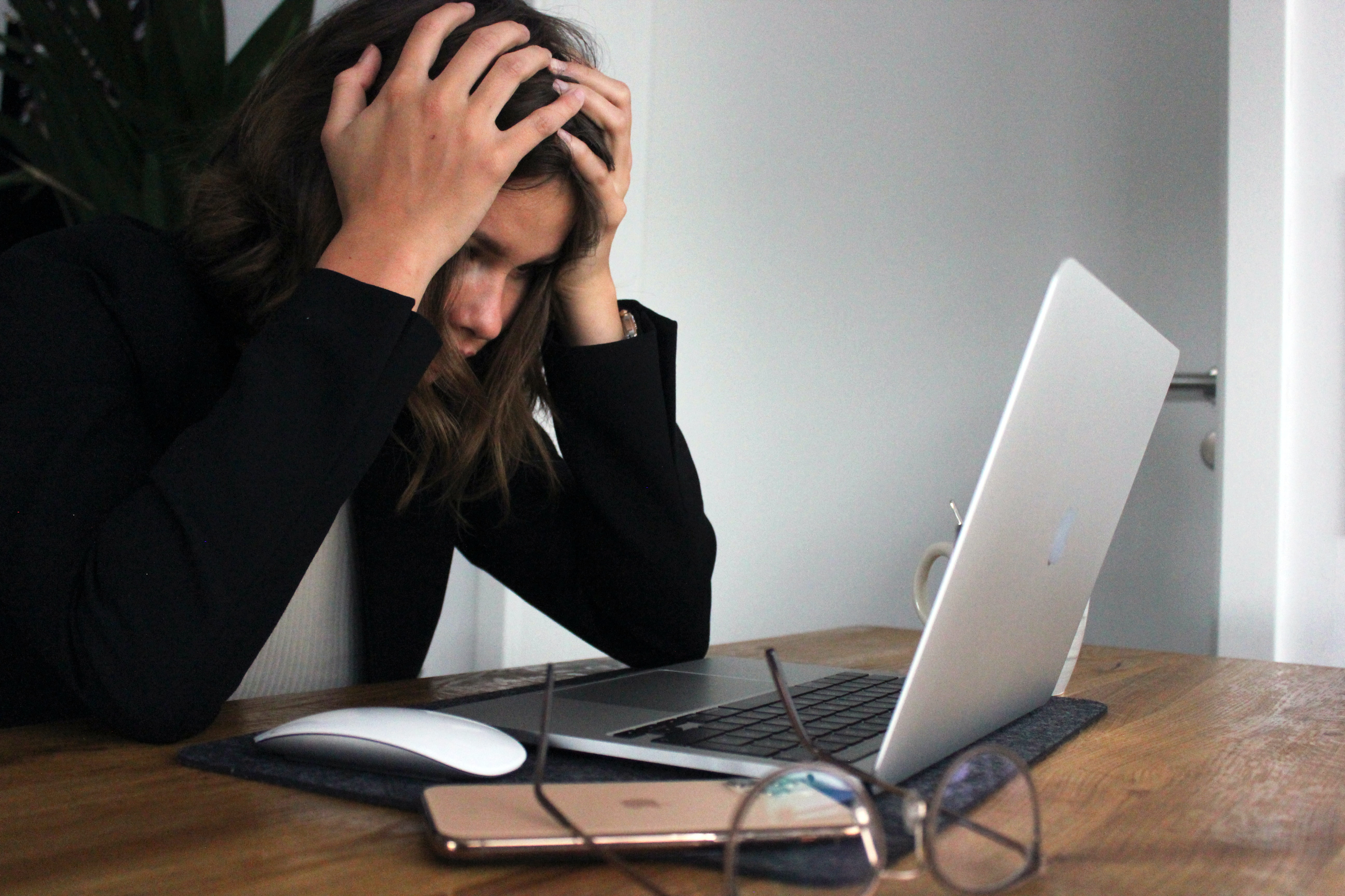 Woman appearing worried looking at desktop screen